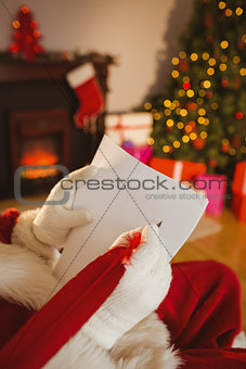 Father christmas writing list with a quill
