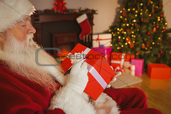 Santa claus writing on a red gift