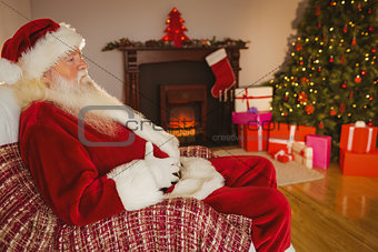 Santa claus sitting and holding his belly