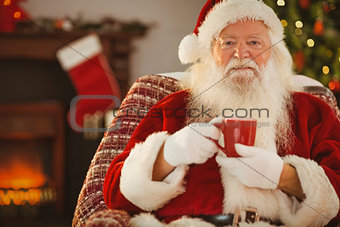 Smiling santa claus holding a mug