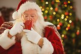 Santa claus drinking a hot beverage