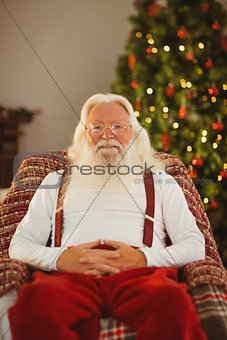 Smiling santa without his jacket relaxing
