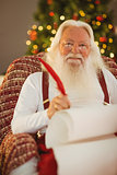 Happy santa writing list on the armchair
