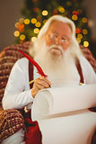 Concentrated santa writing list on the armchair