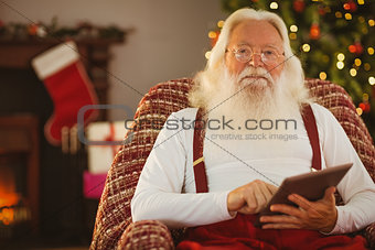 Smiling santa using digital tablet