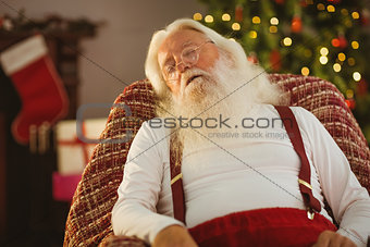Santa claus sleeping on the armchair