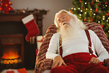 Santa claus napping on the armchair