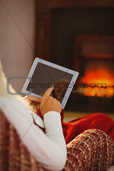 Father christmas touching digital tablet
