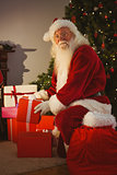 Portrait of santa delivering gifts at christmas eve