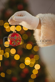 Hand of santa holding a bauble