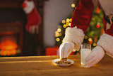 Santa claus picking cookie and glass of milk