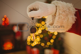 Hand of father christmas holding car key