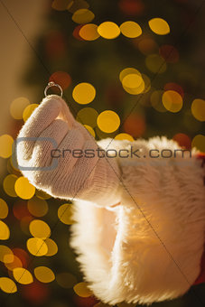 Hand of santa holding engagement ring