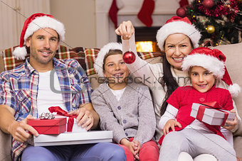 Happy family wearing santa hat on the couch