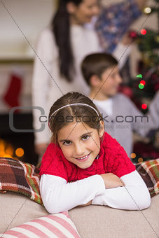 Cute little girl leaning on the couch