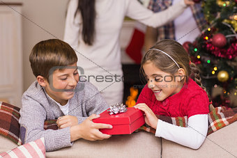 Brother and sister holding a gift