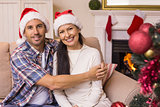 Festive couple hugging on the couch