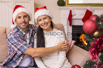 Festive couple hugging on the couch