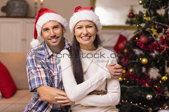 Smiling couple in cuddling on the couch