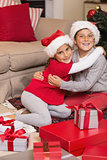 Brother and sister hugging near gifts