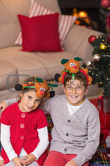 Smiling brother and sister in headband