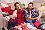 Thinking family sitting and holding gifts