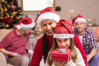 Mother and her daughter posing with gift