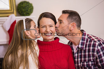 Daughter with her father kissing her mother