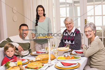 Woman holding christmas dinner with family at dinning table