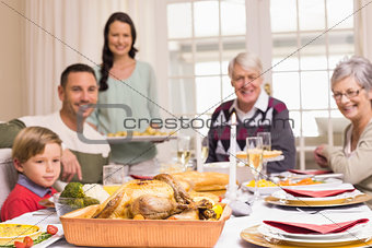 Woman holding christmas dinner with family at dinning table