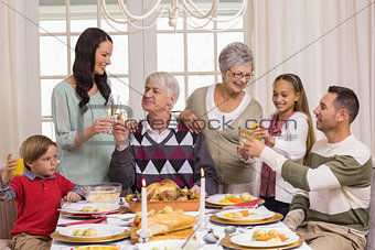 Family toasting with champagne in a christmas dinner