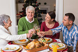 Portrait of happy family toasting at christmas dinner