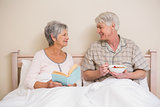 Senior couple relaxing in bed