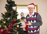 Senior man decorating the christmas tree