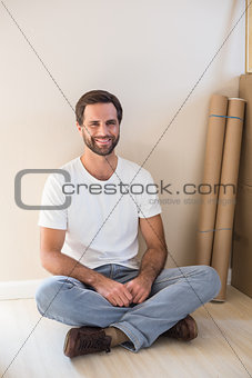 Happy man sitting on the floor