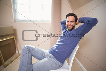 Happy man sitting back after moving in