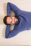 Happy man lying on floor
