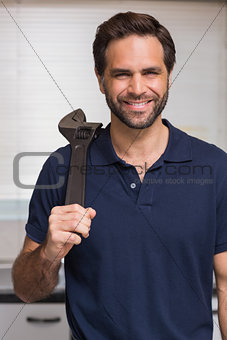 Casual man holding a wrench