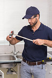 Plumber fixing pipe with wrench