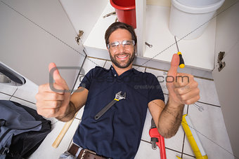 Plumber fixing under the sink