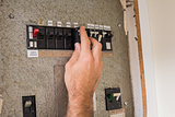 Electrician working on the fuse box