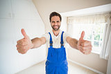 Handyman smiling at camera showing thumbs up