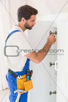 Handyman fixing a wardrobe
