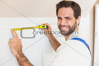 Handyman measuring a wardrobe