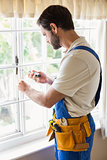 Handyman fixing a window