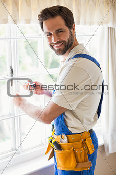Handyman fixing a window
