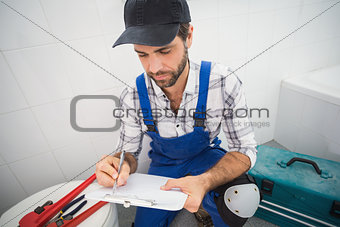 Plumber taking notes on clipboard