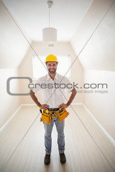 Handyman smiling at camera in tool belt