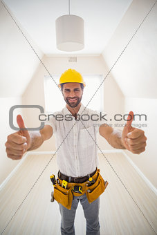 Handyman smiling at camera in tool belt