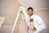 Painter smiling standing on ladder